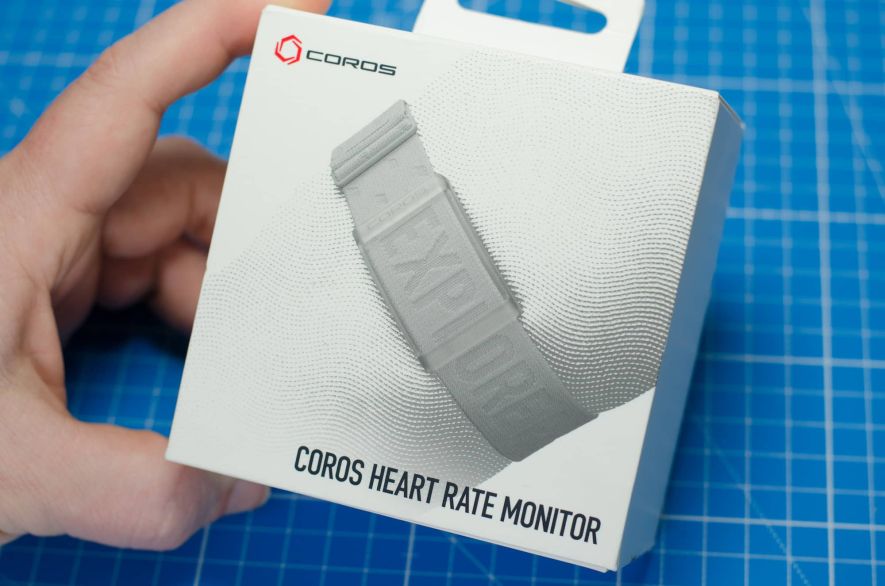 A hand holding the box of the Coros Heart Rate Monitor